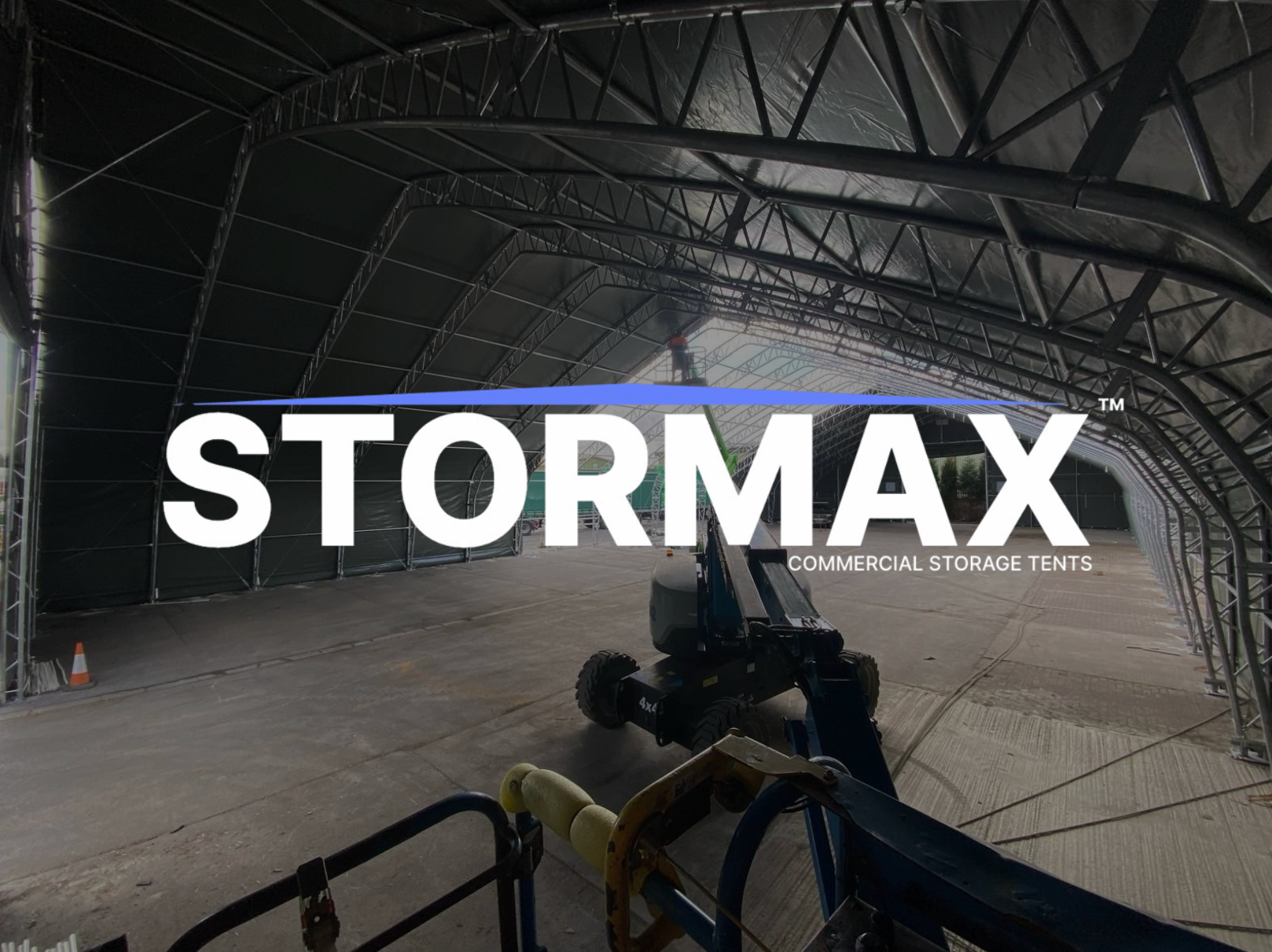 Large indoor storage facility with 'STORMAX by sheltirx' branding on a dark background